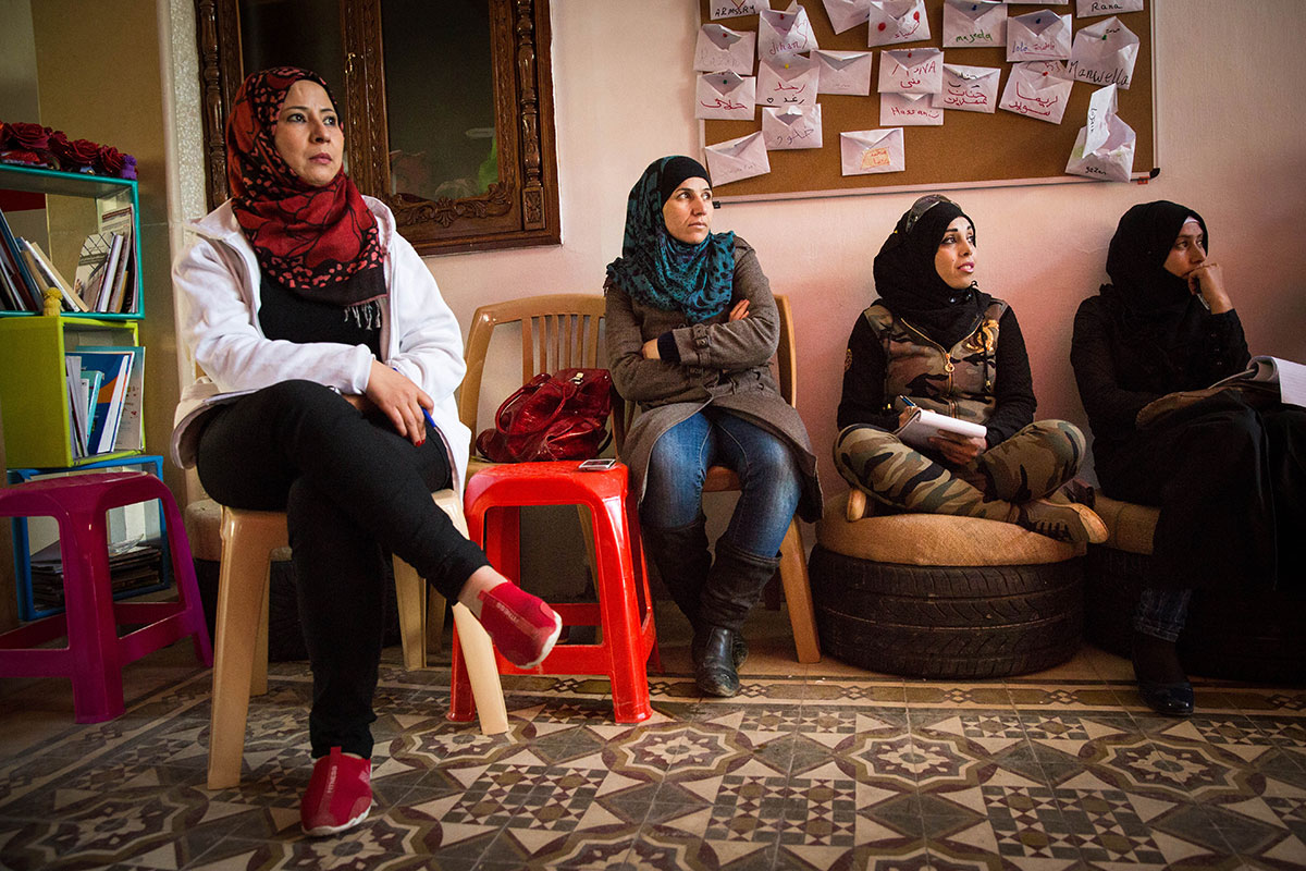 4 refugee women are sitting