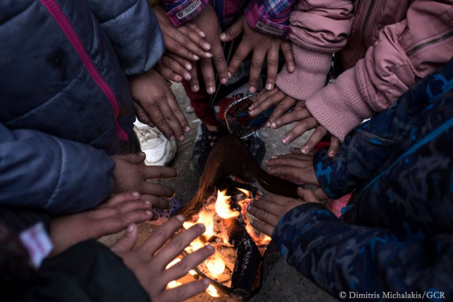 Children hands around the flame