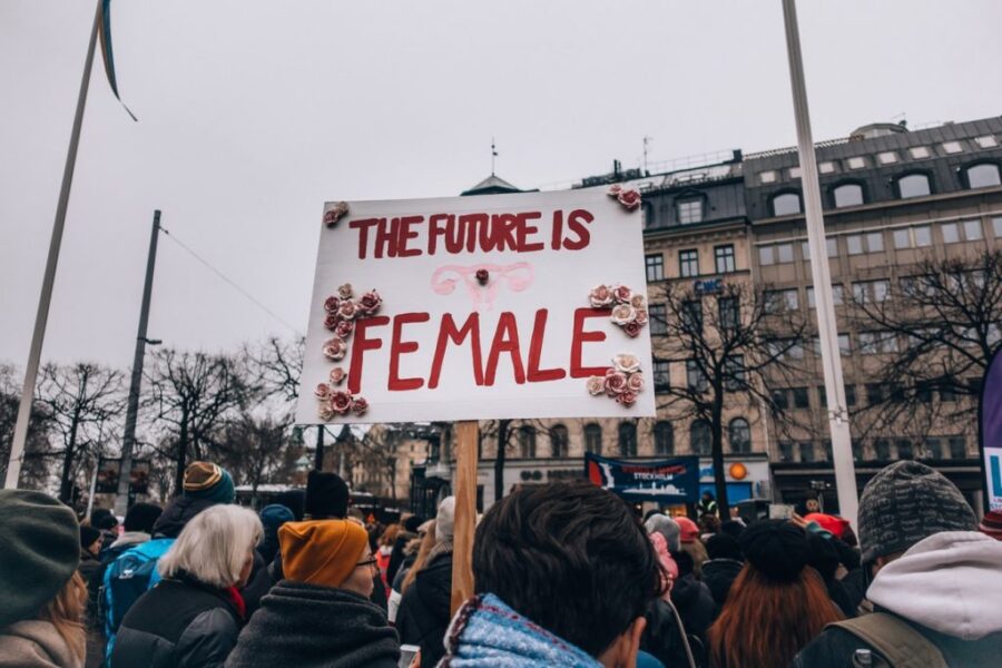 activists hold a sign that read "the future is female"