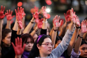 Women's hands, painted red