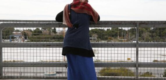 προσφύγισσα ατενίζει από ψηλά έναν υπαίθριο χώρο