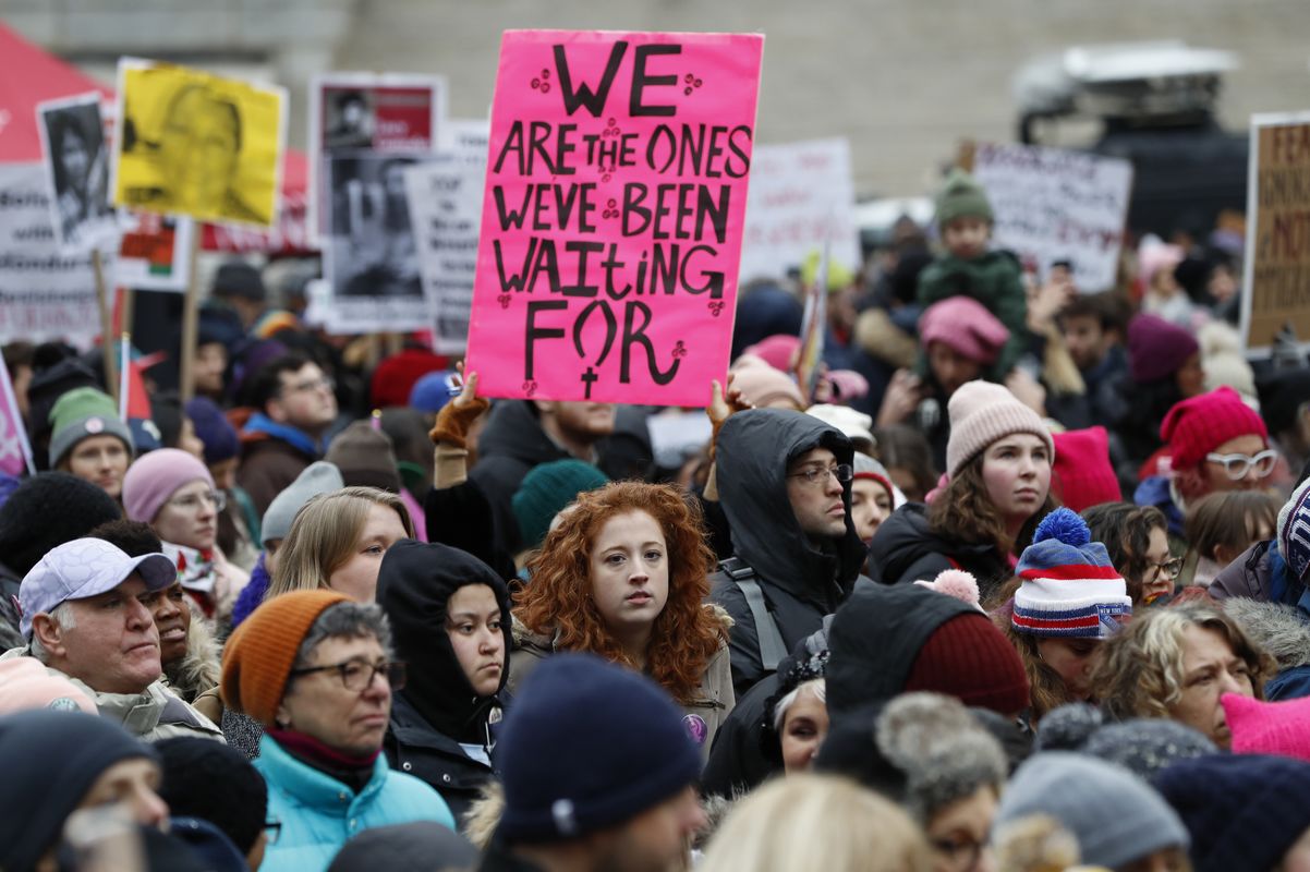 snapshot of a feminist protest in Manhattan, New York, a pink placard reads "We are the ones we've been waiting for"
