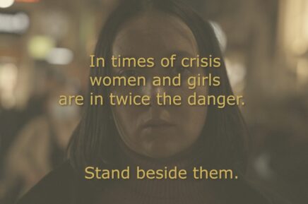 A woman's face is blurred and on the front is written "In times of crisis women and girls are most at risk, stand by them."