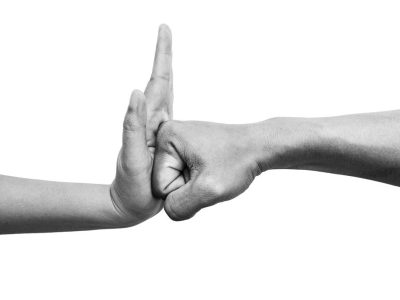 a clenched fist bumps vertically against an open palm